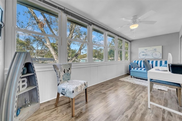 sunroom / solarium with a wealth of natural light and ceiling fan