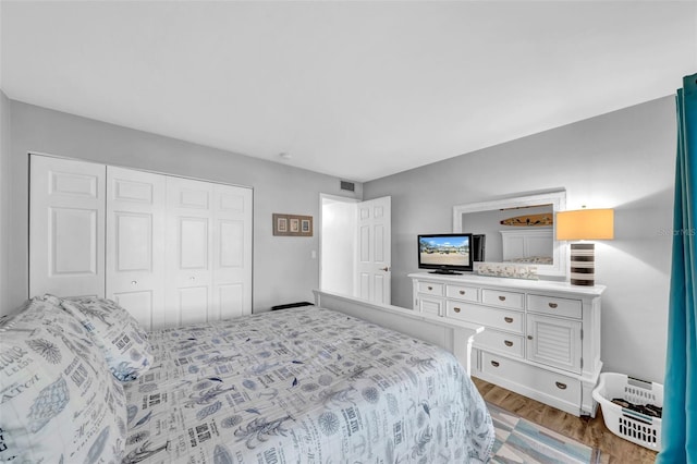 bedroom featuring a closet and light hardwood / wood-style flooring