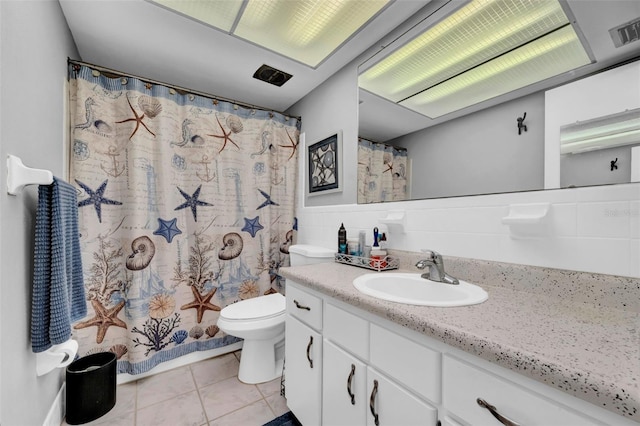 bathroom featuring toilet, a shower with curtain, tile walls, vanity, and tile patterned flooring