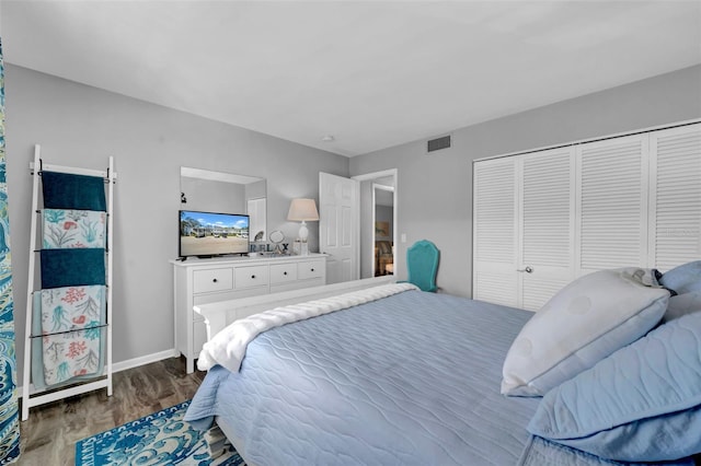 bedroom featuring hardwood / wood-style floors and a closet