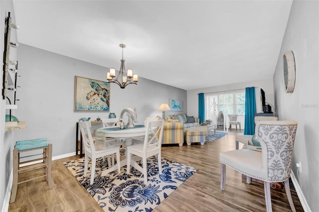 dining area featuring an inviting chandelier and wood-type flooring