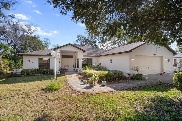 ranch-style house with a garage and a front yard