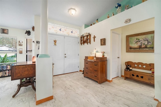 entrance foyer with vaulted ceiling