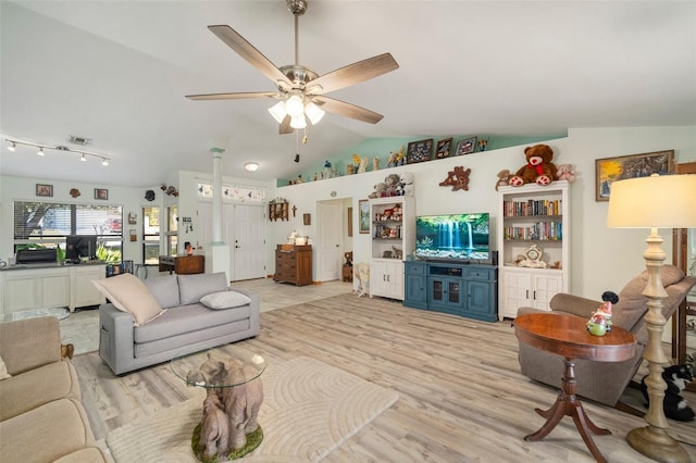 living room featuring vaulted ceiling, ceiling fan, and light hardwood / wood-style flooring