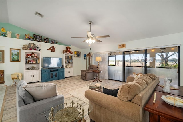 living room featuring vaulted ceiling, ceiling fan, and light wood-type flooring