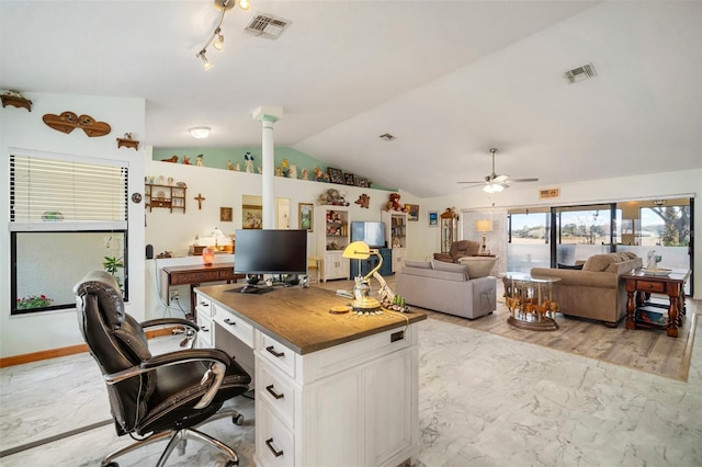 office space featuring lofted ceiling, light hardwood / wood-style flooring, decorative columns, and ceiling fan