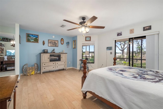 bedroom featuring ceiling fan, light hardwood / wood-style floors, and access to outside