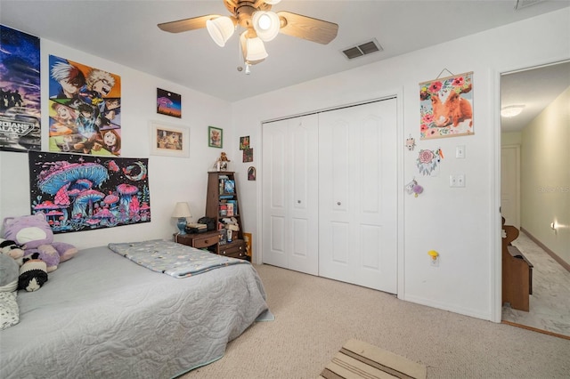 carpeted bedroom featuring ceiling fan and a closet