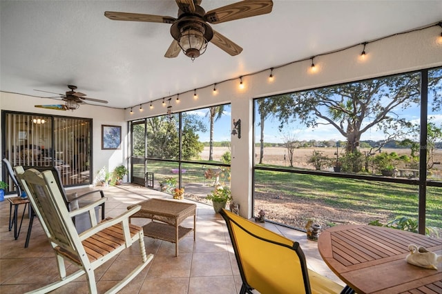 sunroom / solarium featuring ceiling fan