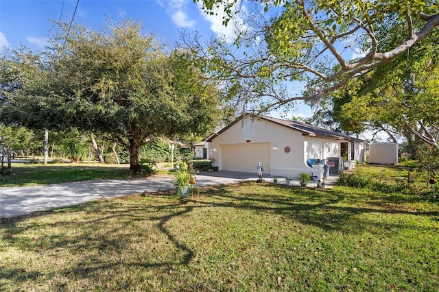 view of property exterior with a garage and a yard