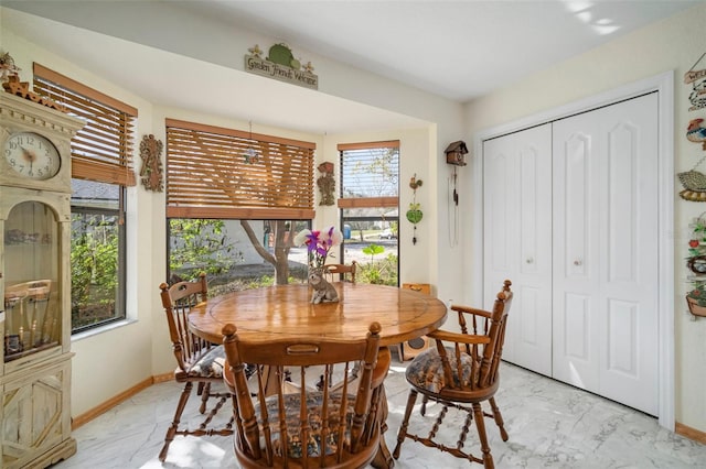 1472 Ivydale Rd, Spring Hill, FL 34606 - dining room featuring light marble finish flooring and baseboards