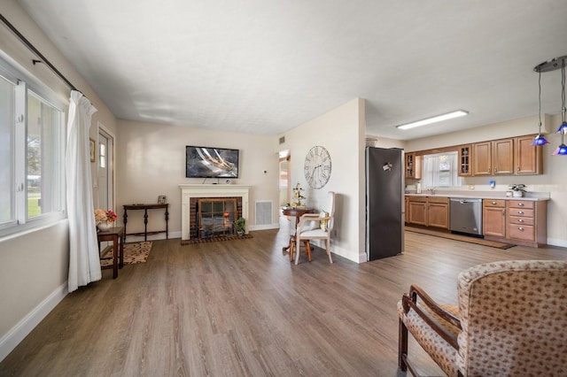 interior space featuring hardwood / wood-style floors and a brick fireplace