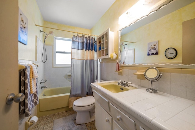 full bathroom featuring shower / tub combo with curtain, vanity, toilet, and tile walls