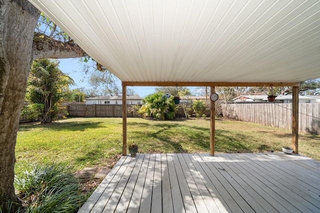 wooden terrace featuring a lawn