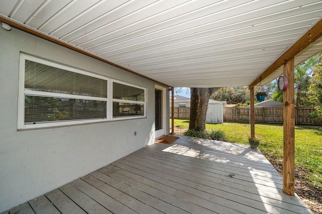 wooden terrace with a lawn