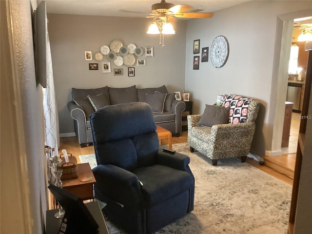 living room with hardwood / wood-style flooring and ceiling fan