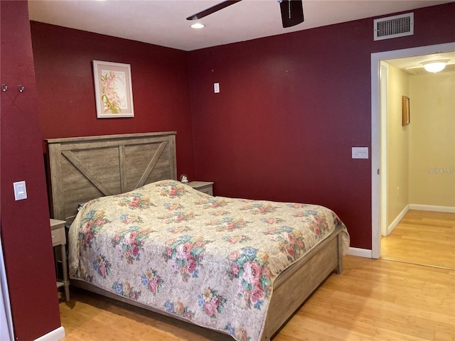 bedroom with ceiling fan and light hardwood / wood-style floors