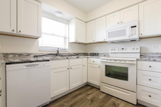 kitchen with sink, white cabinets, light stone counters, dark wood-type flooring, and white appliances