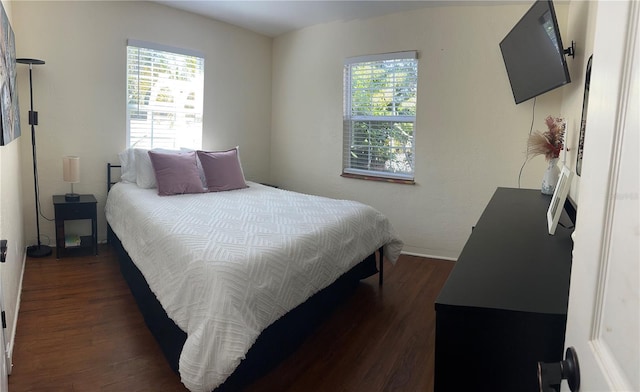 bedroom with dark wood-type flooring