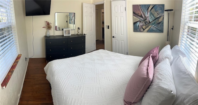 bedroom with dark hardwood / wood-style floors