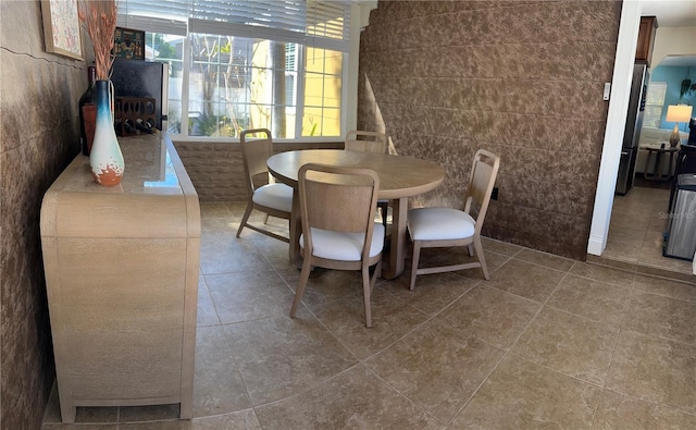 tiled dining room featuring tile walls