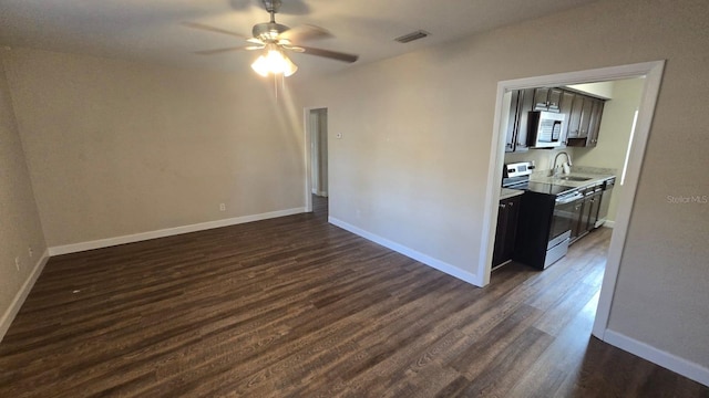 unfurnished room with dark wood-type flooring, ceiling fan, and sink