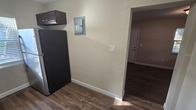 kitchen featuring dark hardwood / wood-style floors, electric panel, and stainless steel refrigerator