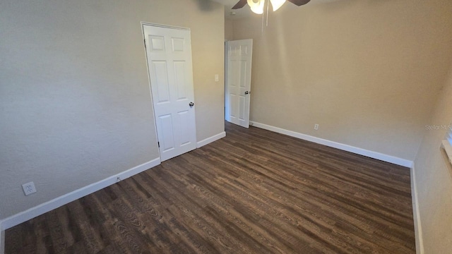 unfurnished room featuring dark hardwood / wood-style floors and ceiling fan