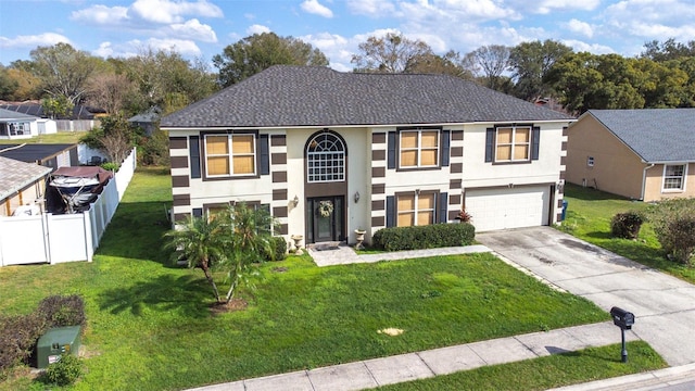 view of front of home featuring a garage and a front lawn