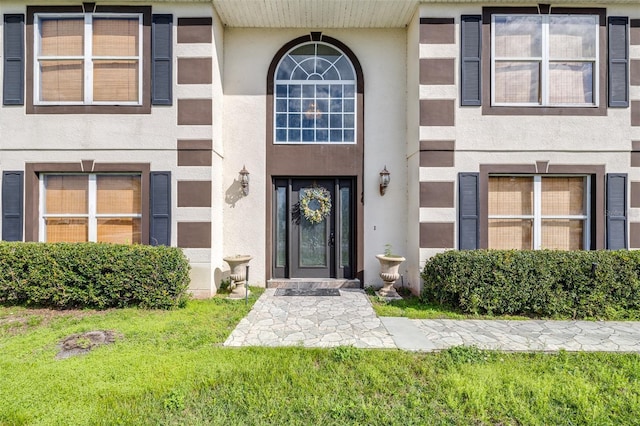 entrance to property with a yard