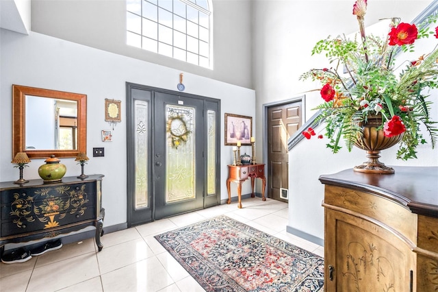 entrance foyer featuring a high ceiling and light tile patterned floors