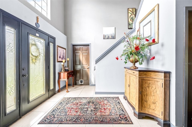 tiled foyer entrance with a high ceiling