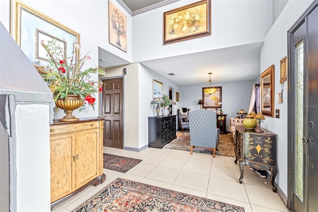 tiled foyer entrance featuring a towering ceiling