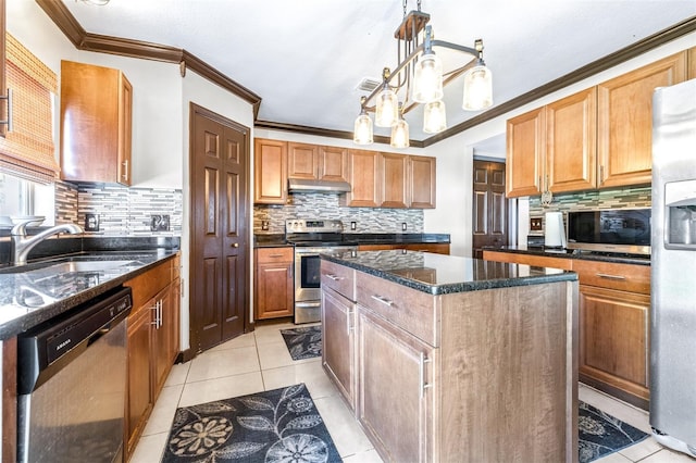 kitchen with light tile patterned flooring, a kitchen island, appliances with stainless steel finishes, sink, and dark stone counters