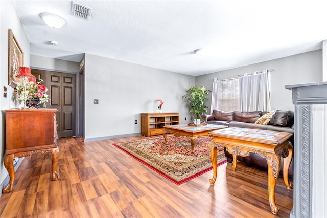 living room featuring hardwood / wood-style flooring and a textured ceiling