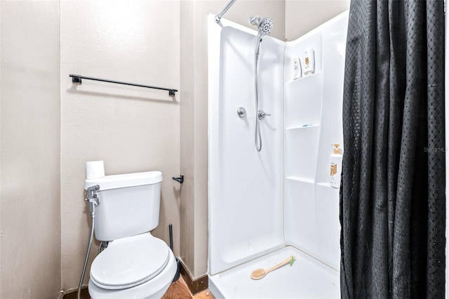 bathroom with a shower with curtain and toilet