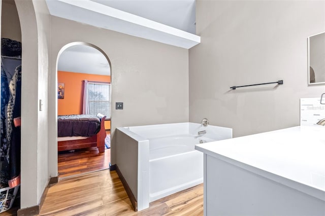 bathroom with sink, hardwood / wood-style floors, and a washtub