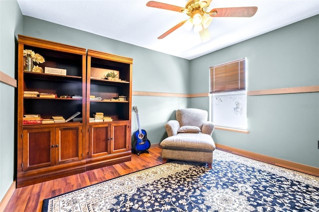 sitting room with hardwood / wood-style flooring and ceiling fan