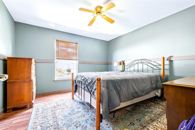 bedroom with ceiling fan and wood-type flooring