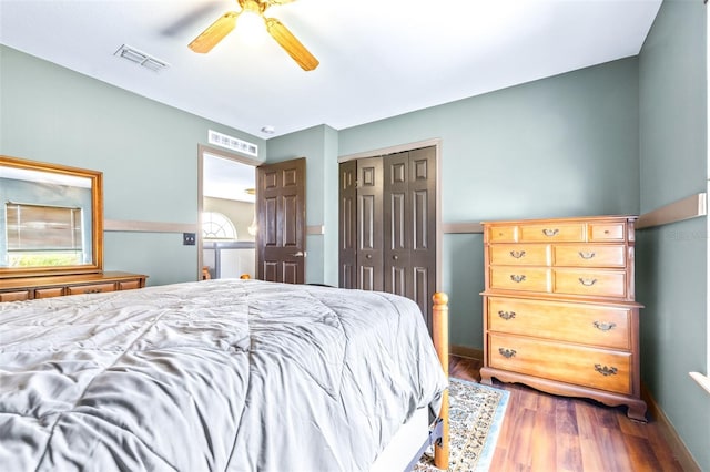 bedroom featuring wood-type flooring, ceiling fan, and a closet