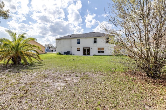 rear view of house featuring a yard and cooling unit