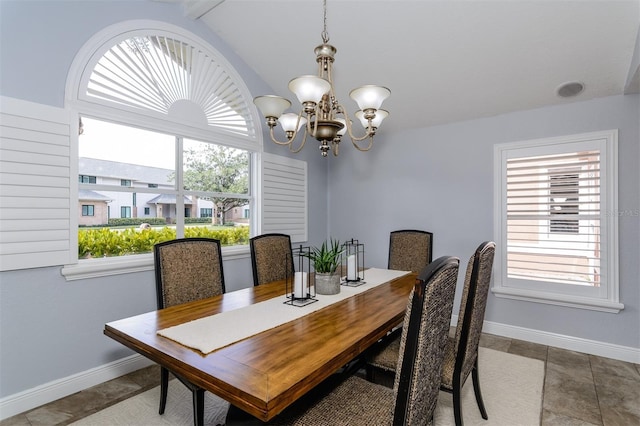 dining area featuring an inviting chandelier and lofted ceiling