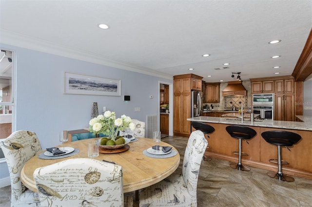 dining area featuring ornamental molding and light parquet flooring