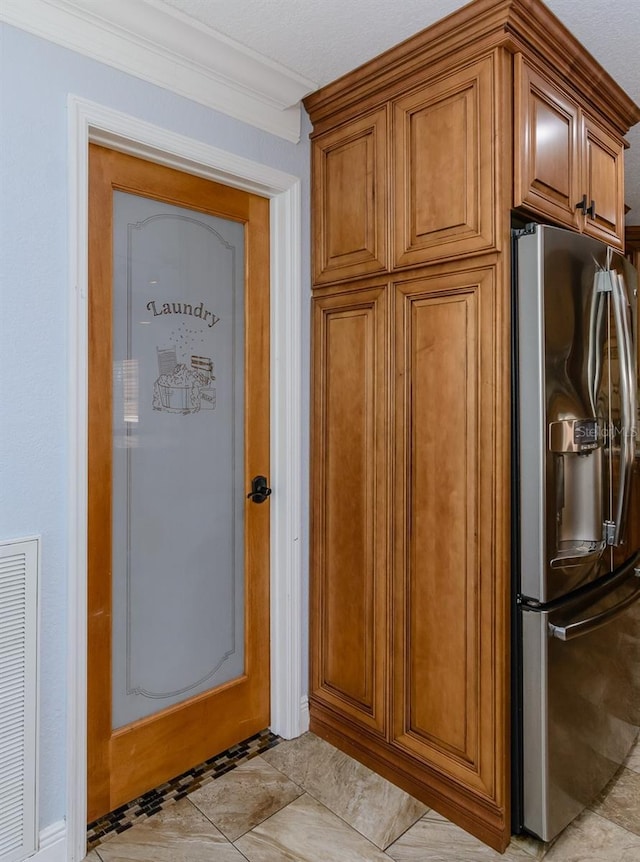 kitchen featuring stainless steel refrigerator with ice dispenser and crown molding