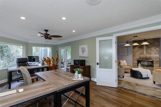 office area featuring a tiled fireplace, hardwood / wood-style flooring, plenty of natural light, and french doors