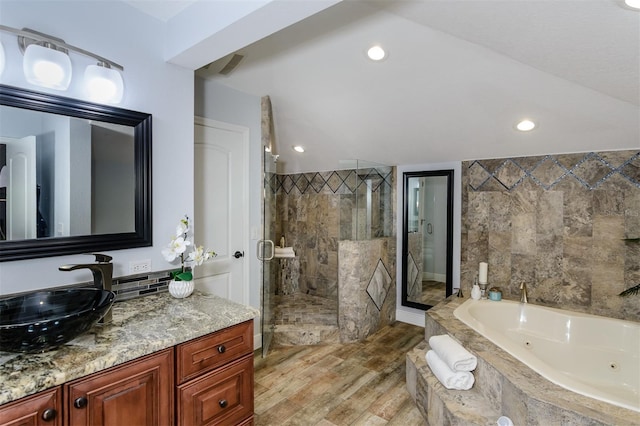 bathroom with vanity, separate shower and tub, and hardwood / wood-style floors