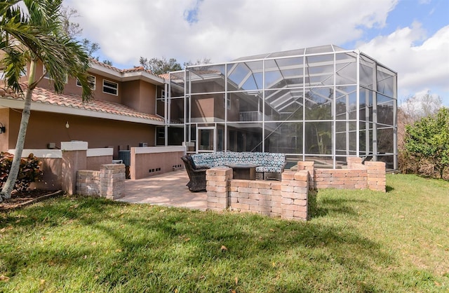 rear view of property with a patio and a lawn