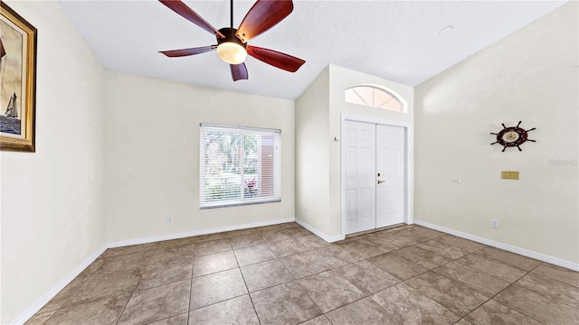 entrance foyer with light tile patterned floors and ceiling fan