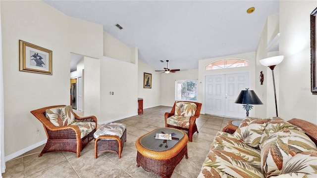 tiled living room featuring ceiling fan and high vaulted ceiling