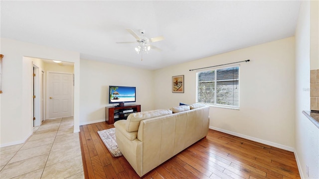 living room with ceiling fan and light hardwood / wood-style floors